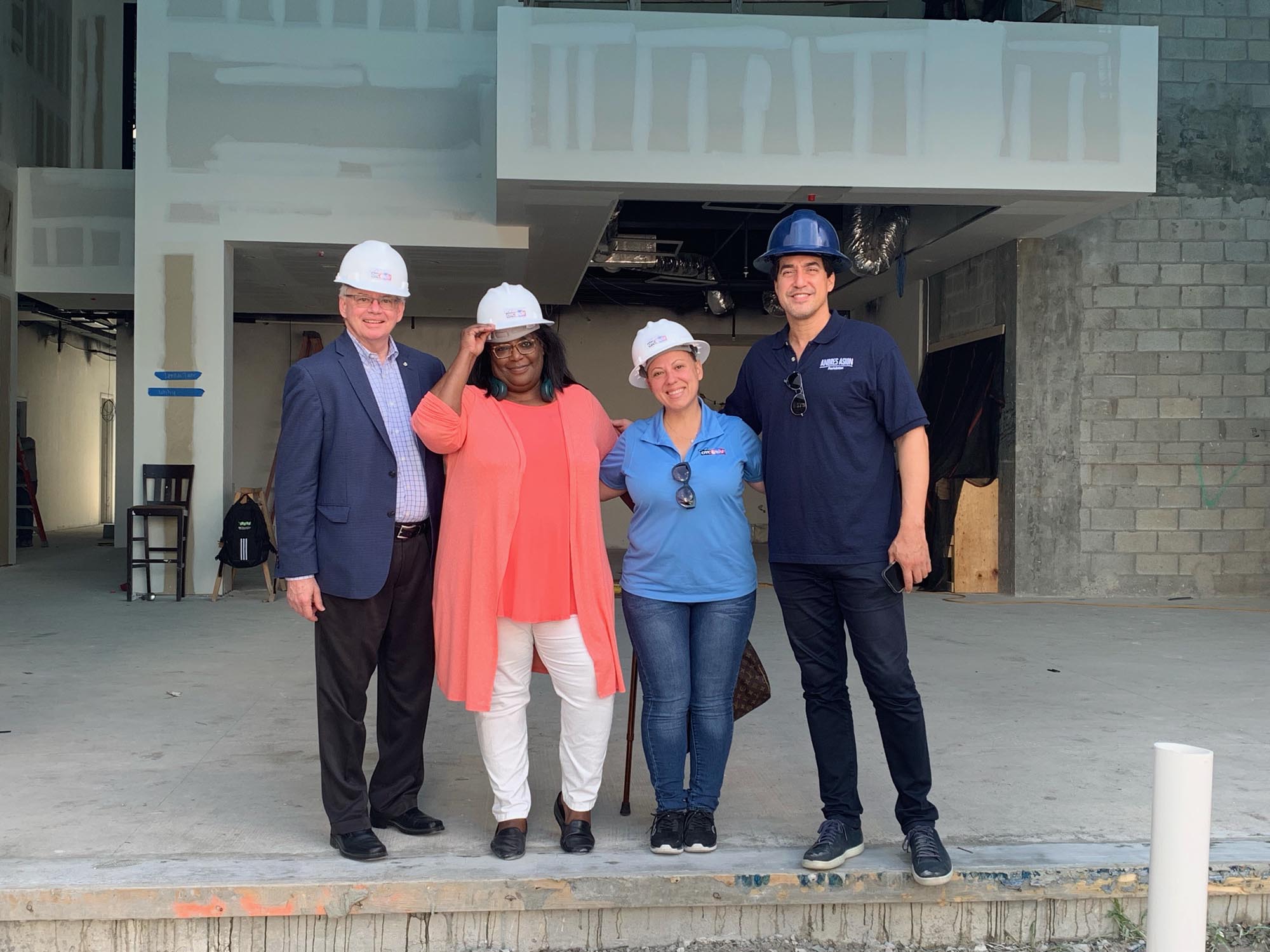 Staff from Miami-Dade County’s Office of the Mayor Daniella Levine Cava pose for a photo in front of the new OYC Center construction site.