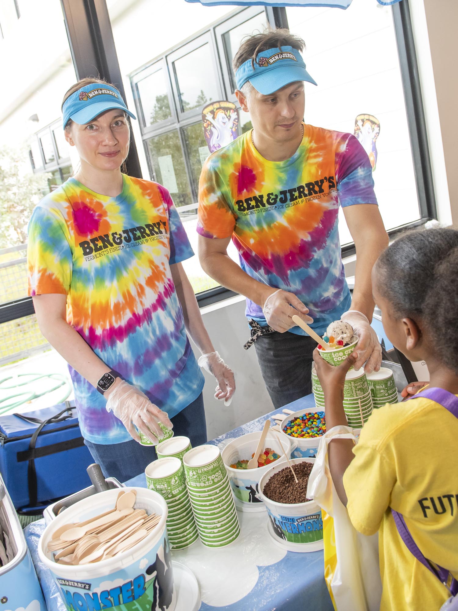 Representatives from Ben and Jerry's serve ice cream to the OYC students during Fall festivities