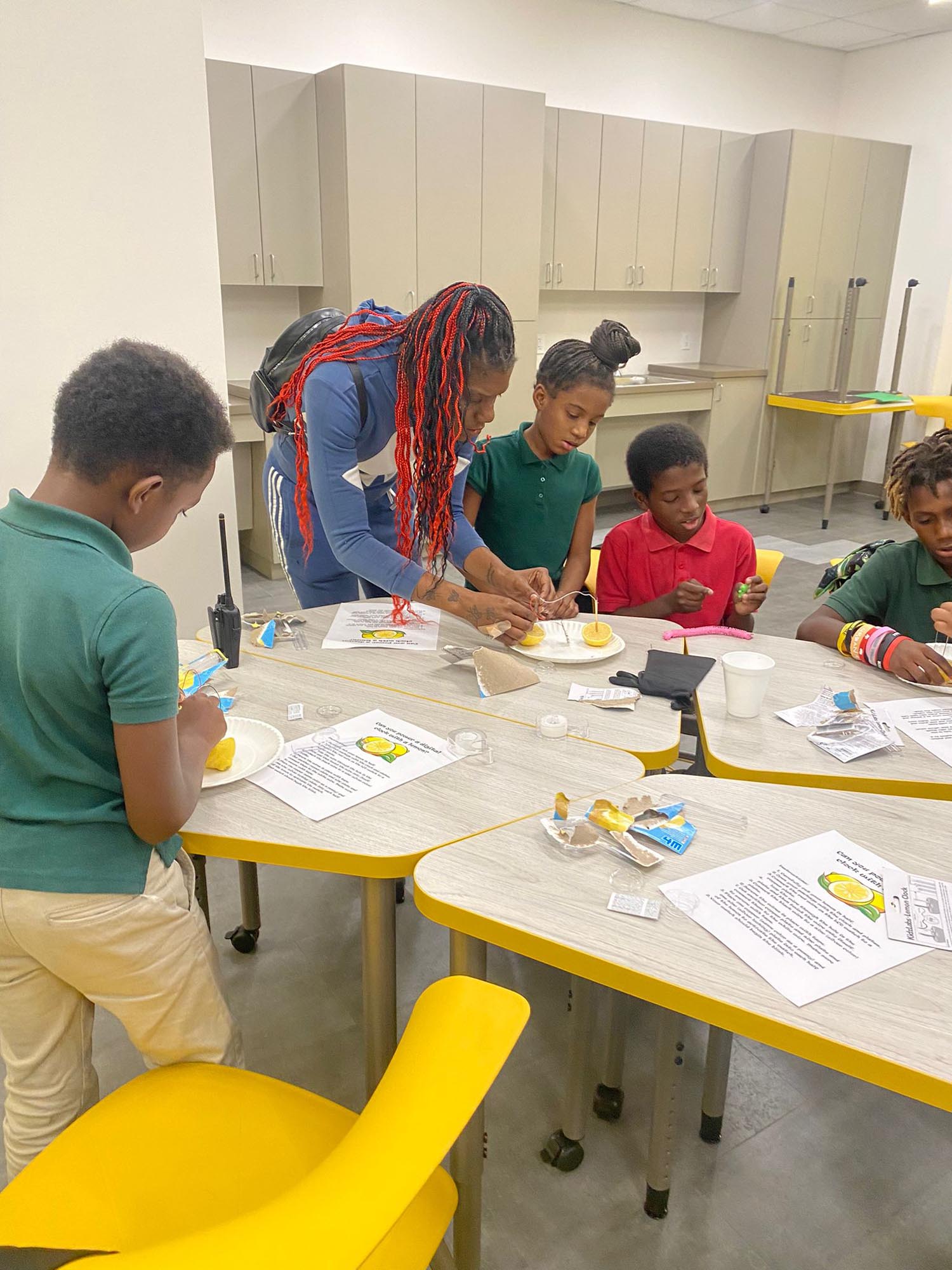 Families construct clocks powered by lemons on OYC STEM Night