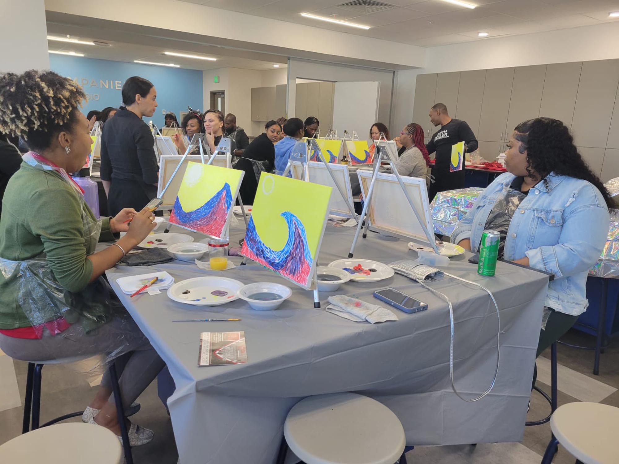 The OYC team participates in painting with Paint with Faith and works on creating unique art during the event.