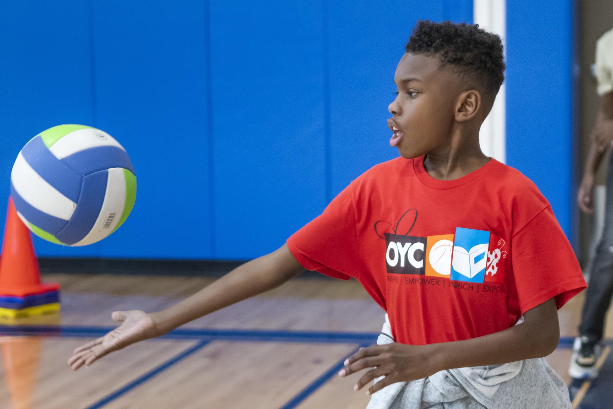 a young boy plays volleyball at OYC Miami