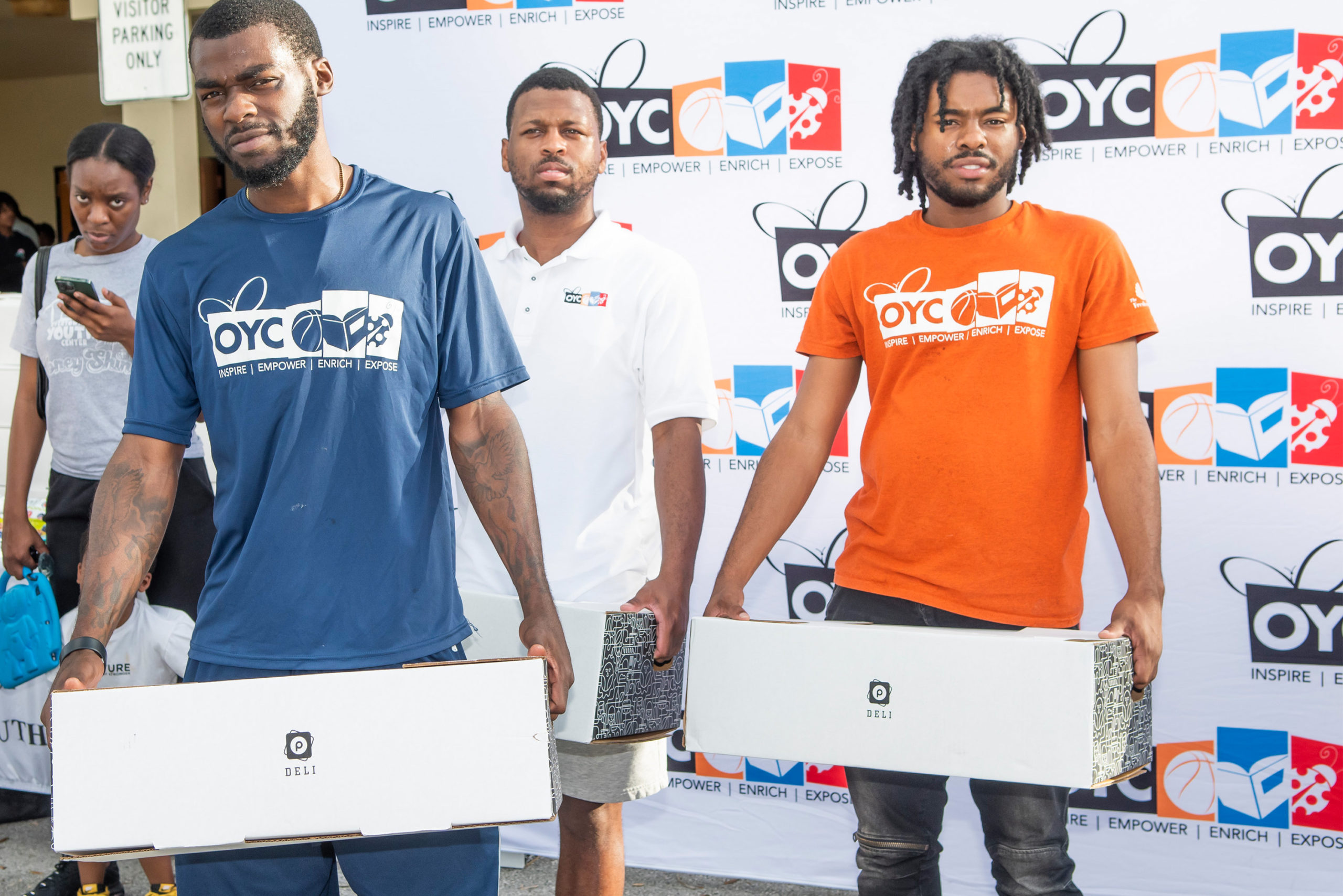 young men distribute turkeys at OYC Miami's Thanksgiving drive